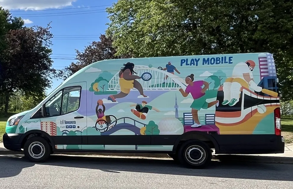 A brightly painted van depicting people playing sports that reads Play Mobile on the side.