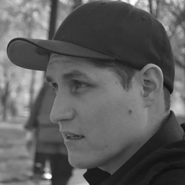 A man wearing baseball cap in black and white
